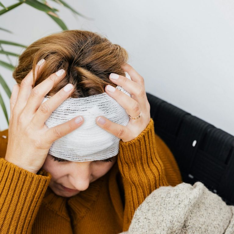 pexels-photo-5207232-5207232 Woman with head injury holding her head in pain indoors.
